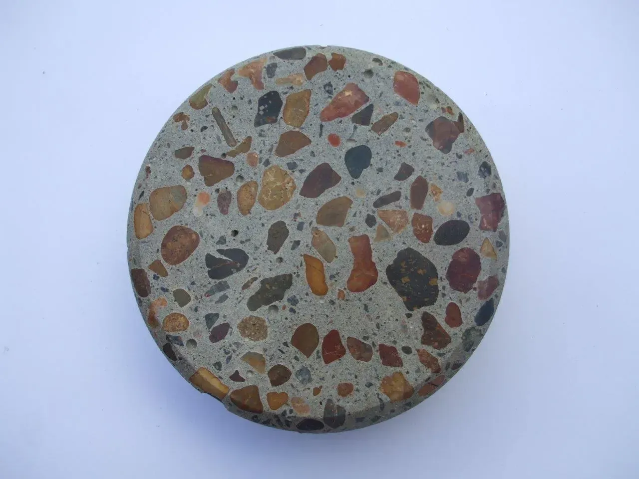 A close up of a rock with many different coloured rocks on it — Concrete Colour Solutions in Morisset, NSW