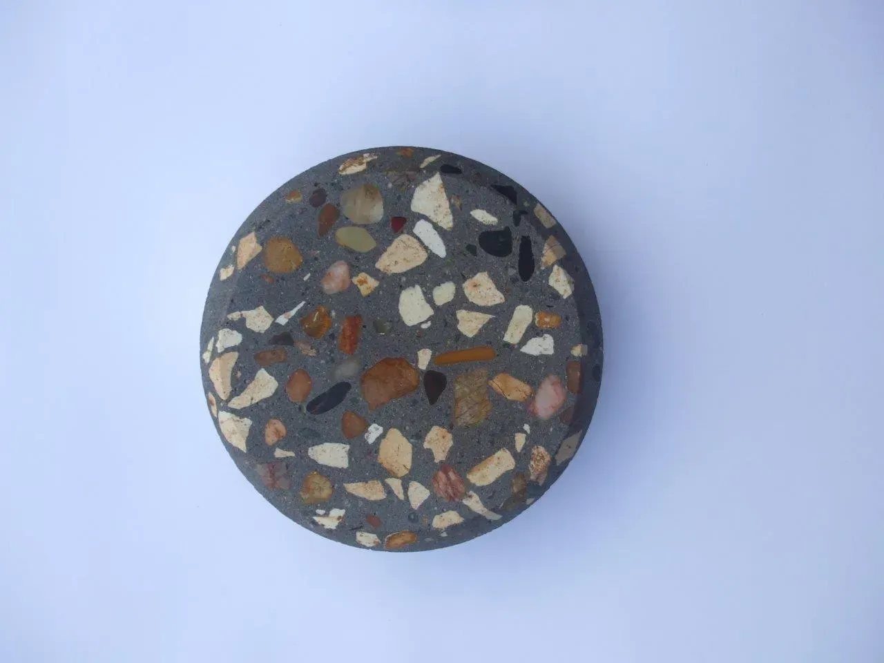 A close up of a rock on a white surface — Concrete Colour Solutions in Morisset, NSW