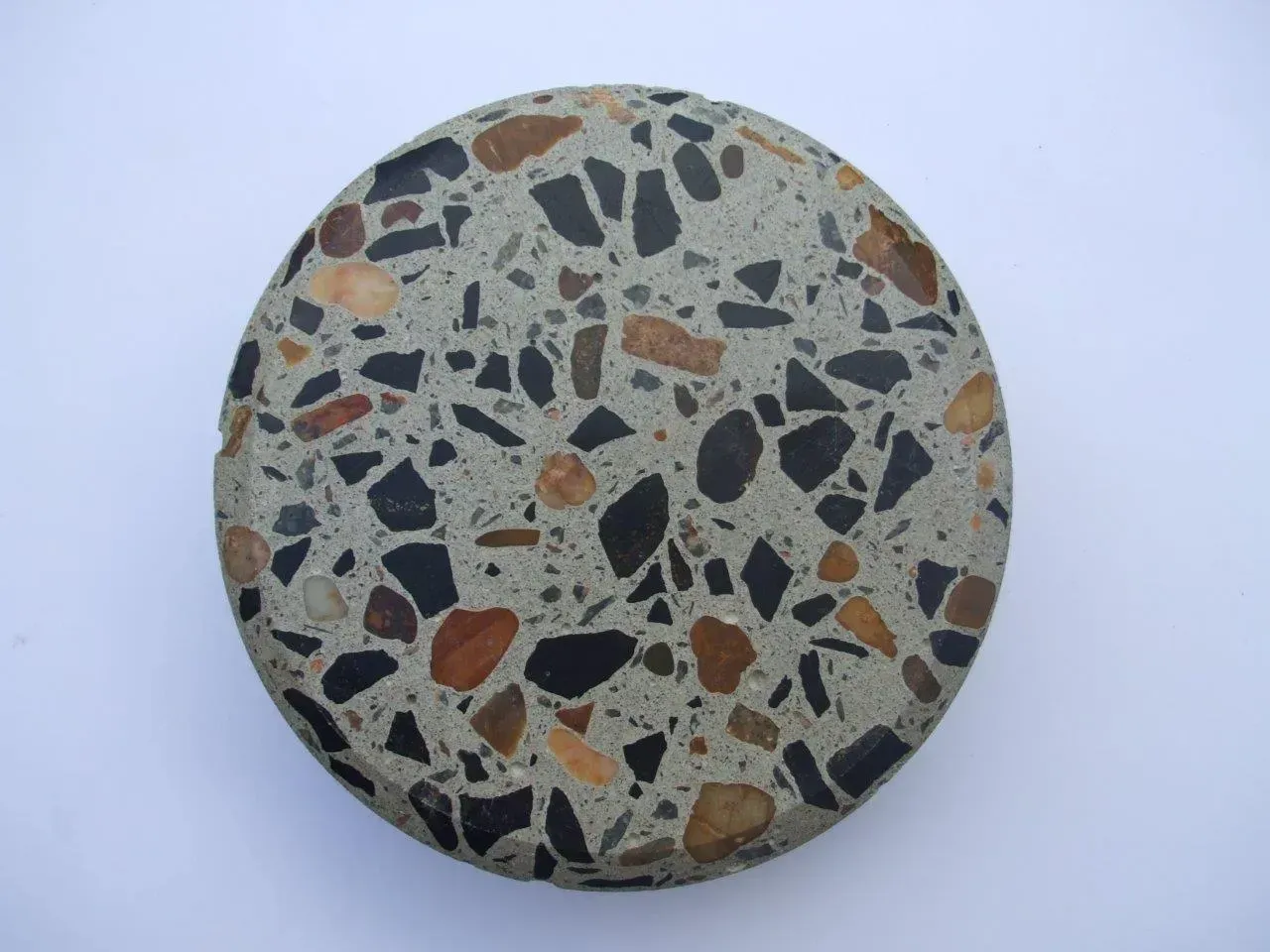A round stone with a pattern of rocks on it — Concrete Colour Solutions in Morisset, NSW