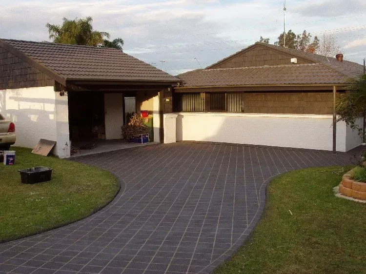 A driveway leading to a house with a car parked in front of it — Concrete Colour Solutions in Morisset, NSW