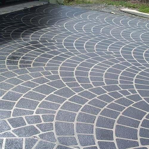A stencilled driveway with a circular pattern on it. — Concrete Colour Solutions in Morisset, NSW
