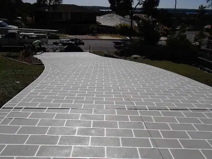 A Driveway with A Brick Pattern Painted on It — Concrete Colour Solutions in Cessnock, NSW