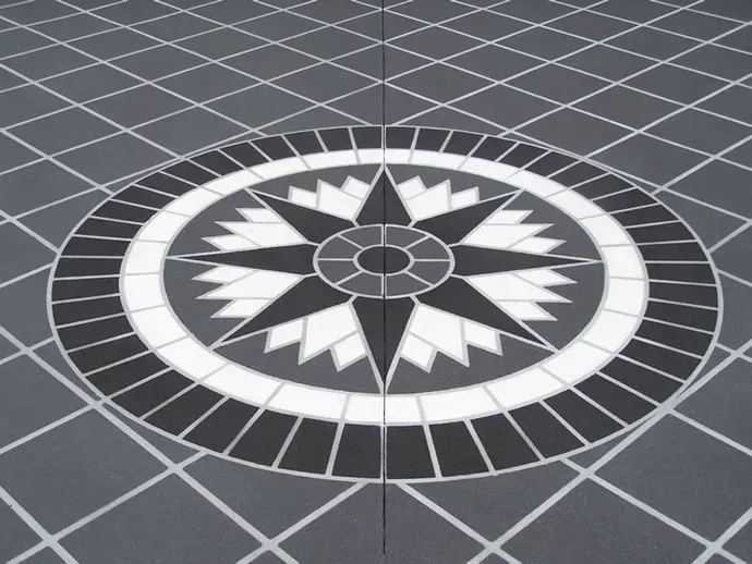 A Black and White Circular Pattern on A Tiled Floor — Concrete Colour Solutions in Morisset, NSW