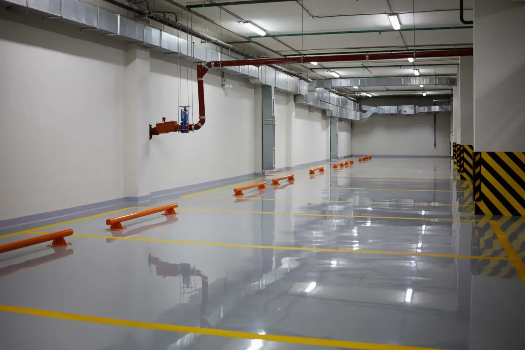 An Empty Parking Garage with A Concrete Floor and Yellow Lines — Concrete Colour Solutions in Morisset, NSW