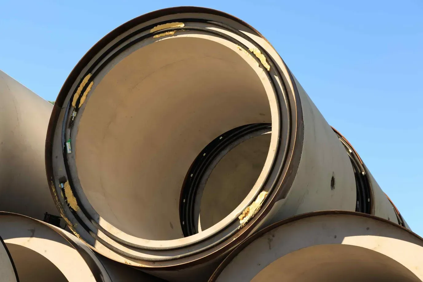 A Bunch of Pipes Are Stacked on Top of Each Other — Concrete Colour Solutions in Morisset, NSW