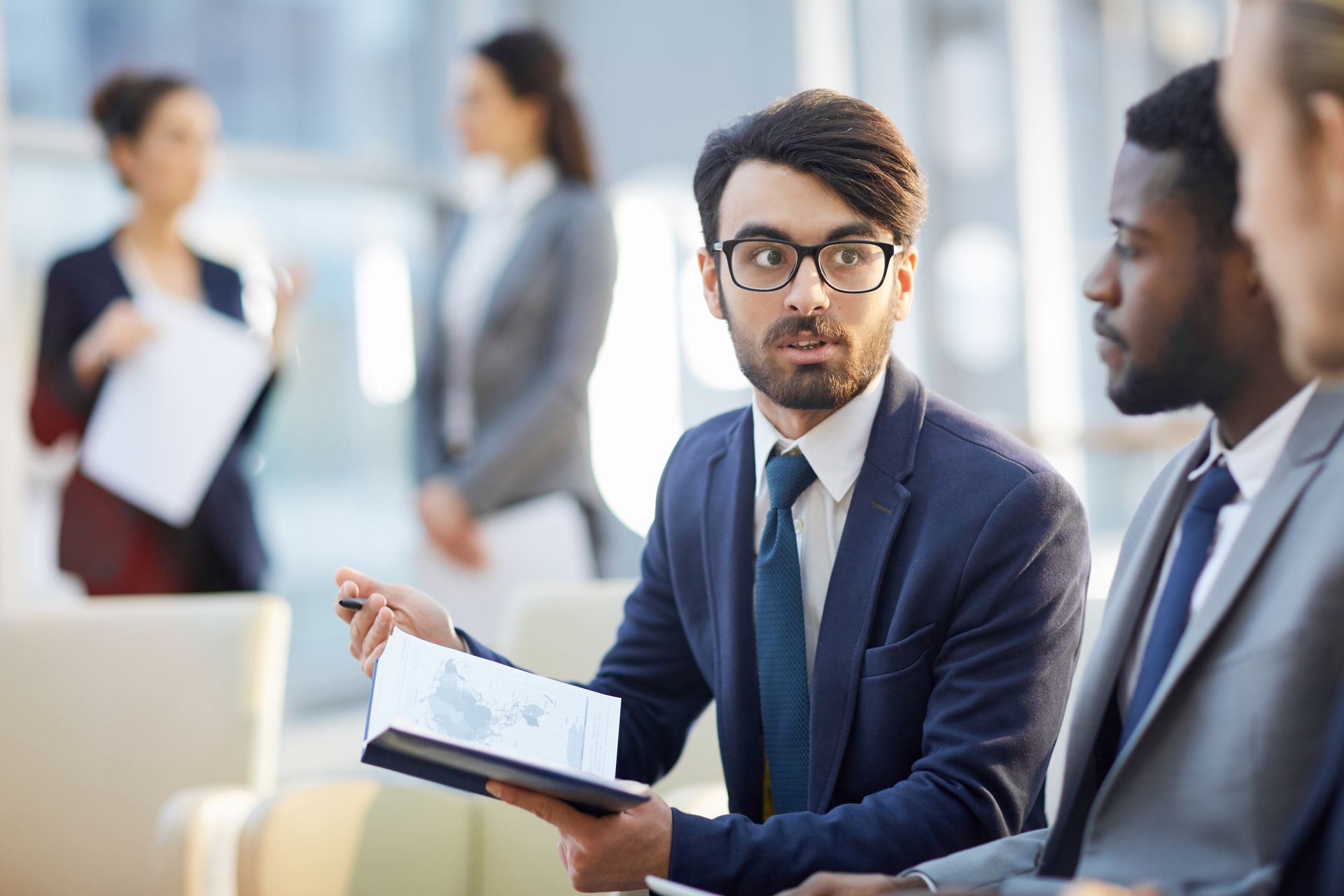 A group of business people are having a meeting in an office.