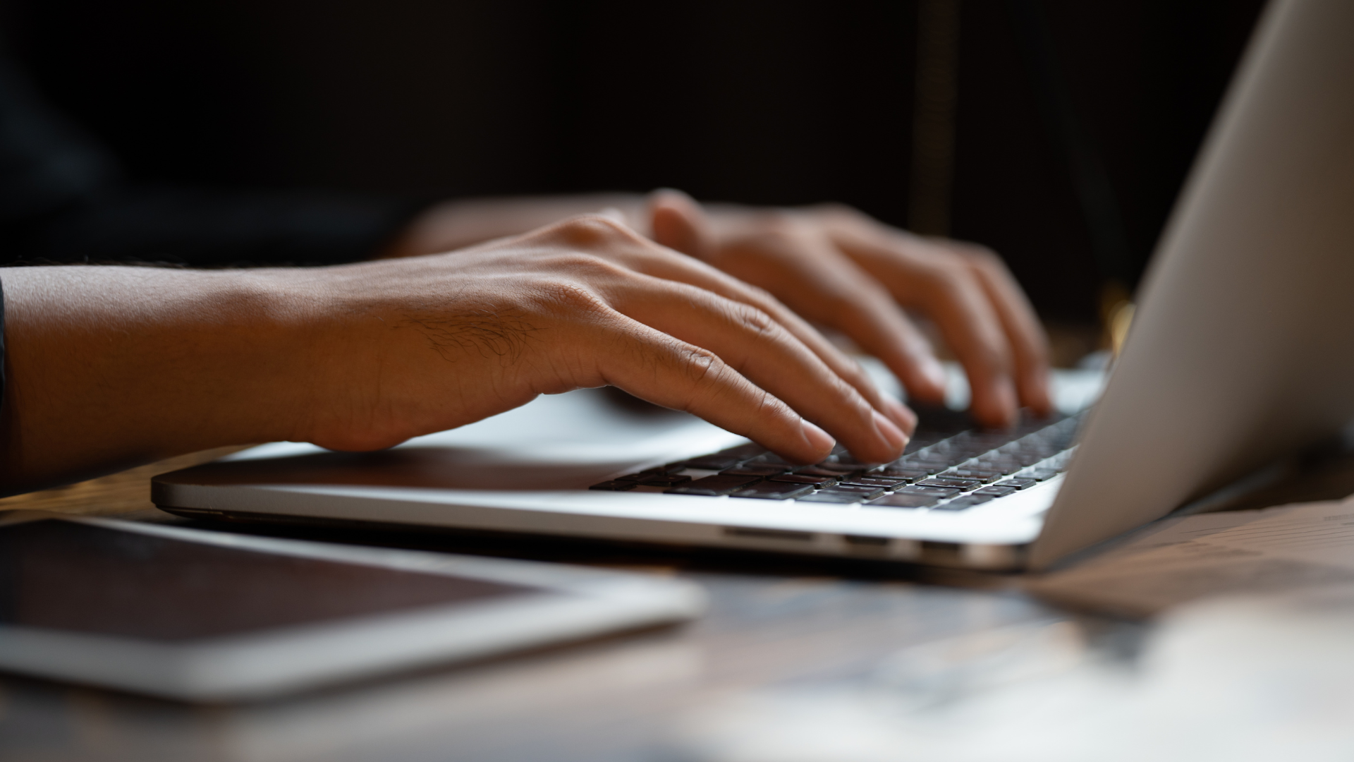 A person is typing on a laptop computer.