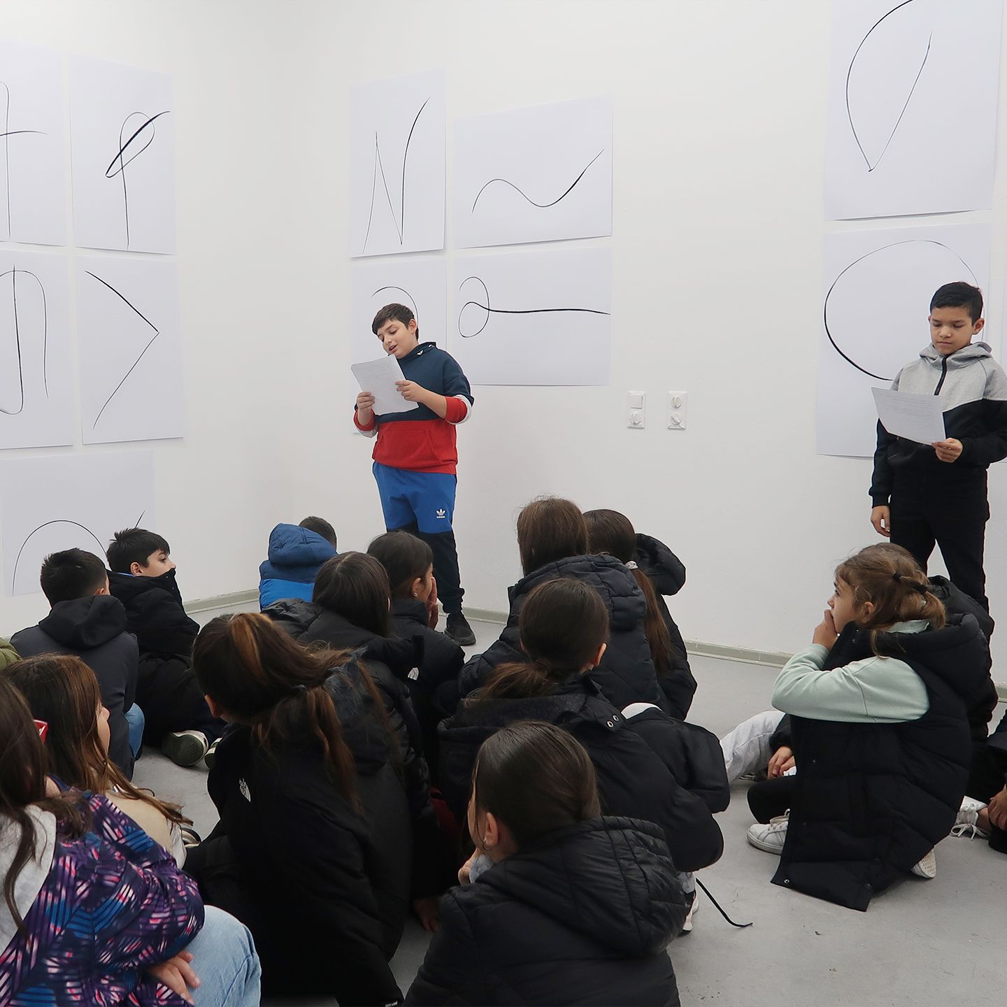 Boy presents his works to fellow students, teachers and parents.