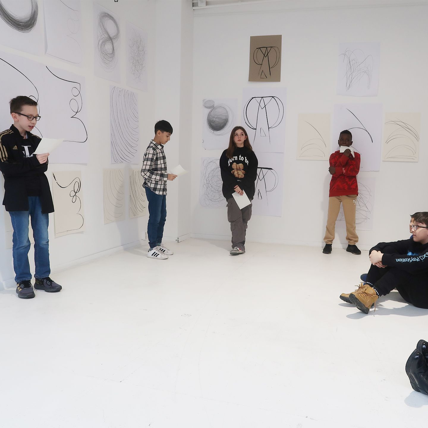 Boy presents his works to fellow students.