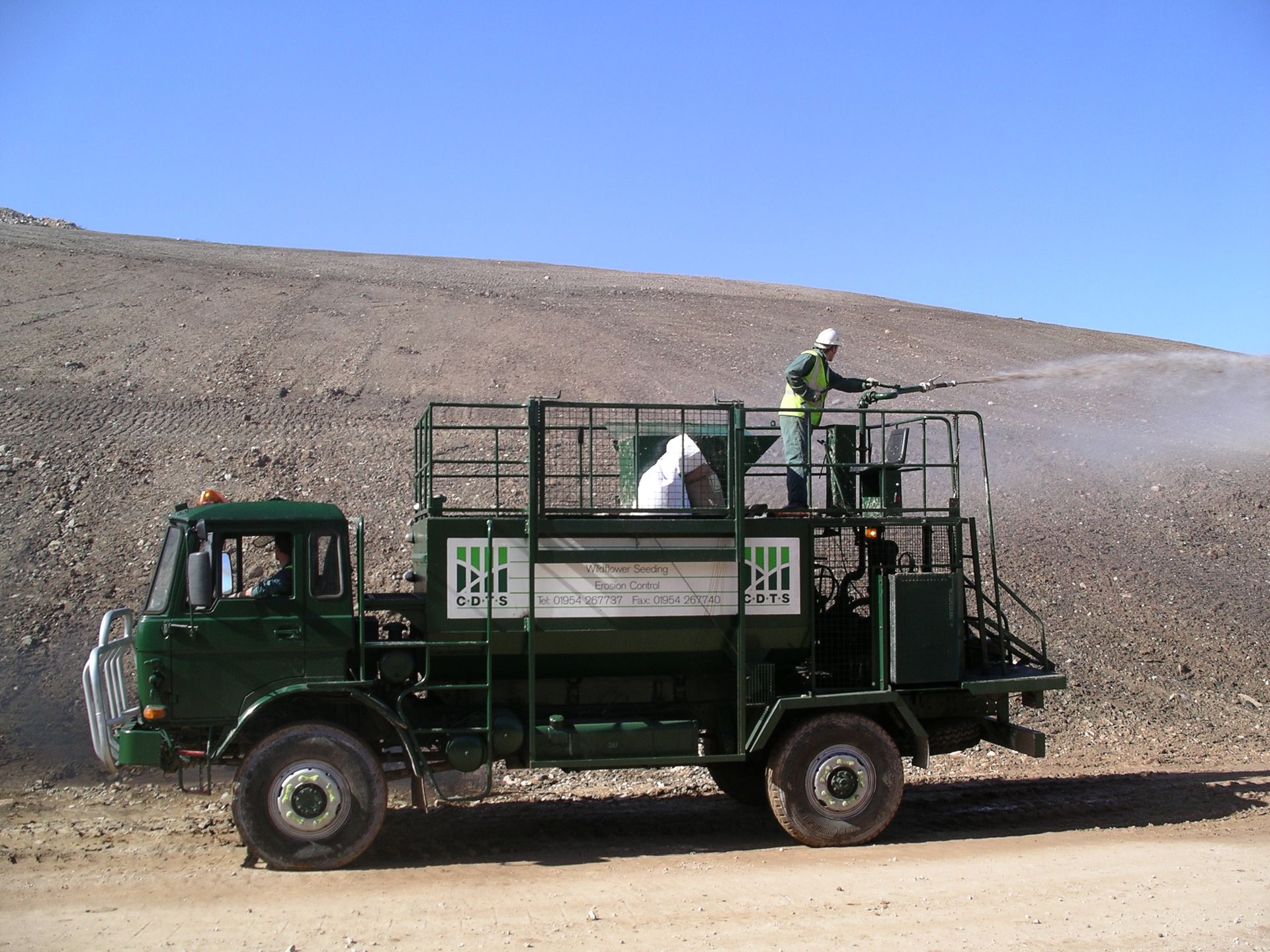 CDTS's largest hydroseeder, a 6,000-litre Finn lorry-mounted unit, applying hydraulic seeding mulch to an embankment