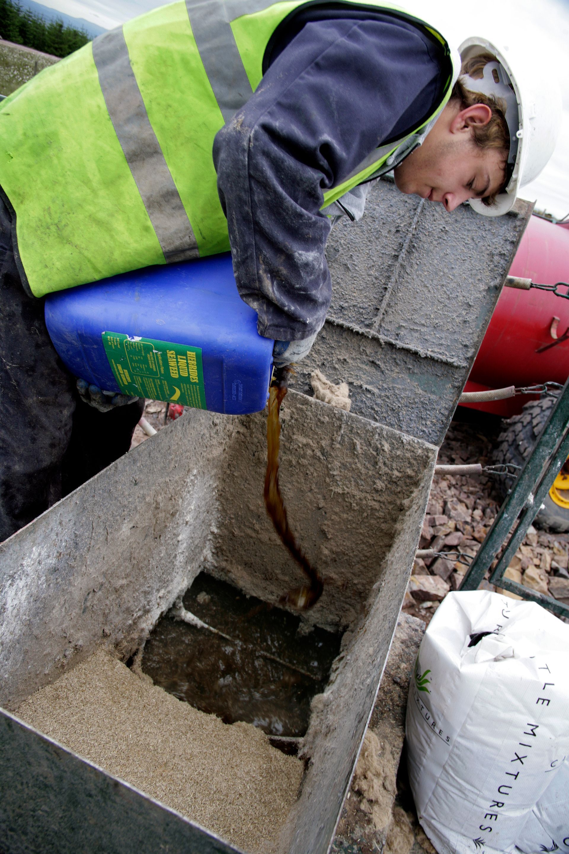 A CDTS operative adding liquid fertiliser to the hydroseeding tank at Clyde Wind Farm in Lancashire