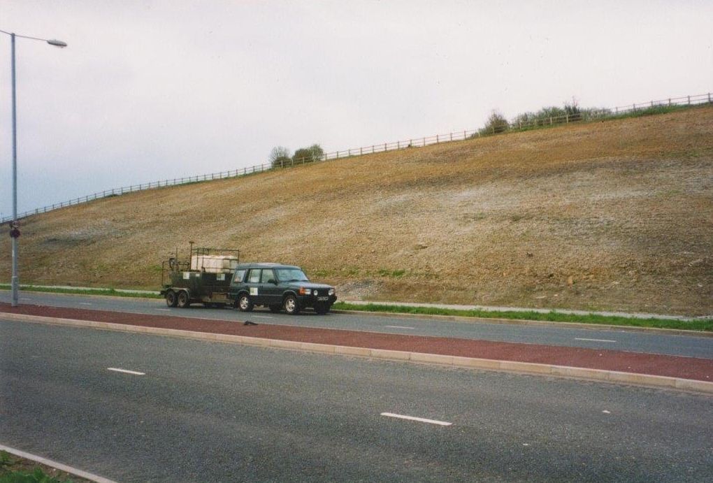 Bare highway embankment with hostile, low-nutrient soil prior to direct tree seeding treatment, 1997