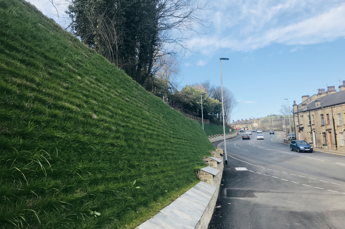 Hydroseeding through pre-installed erosion blanket matting on a critical slope