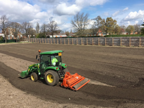 John Deere tractor with stone burier preparing seedbed for conventional seeding