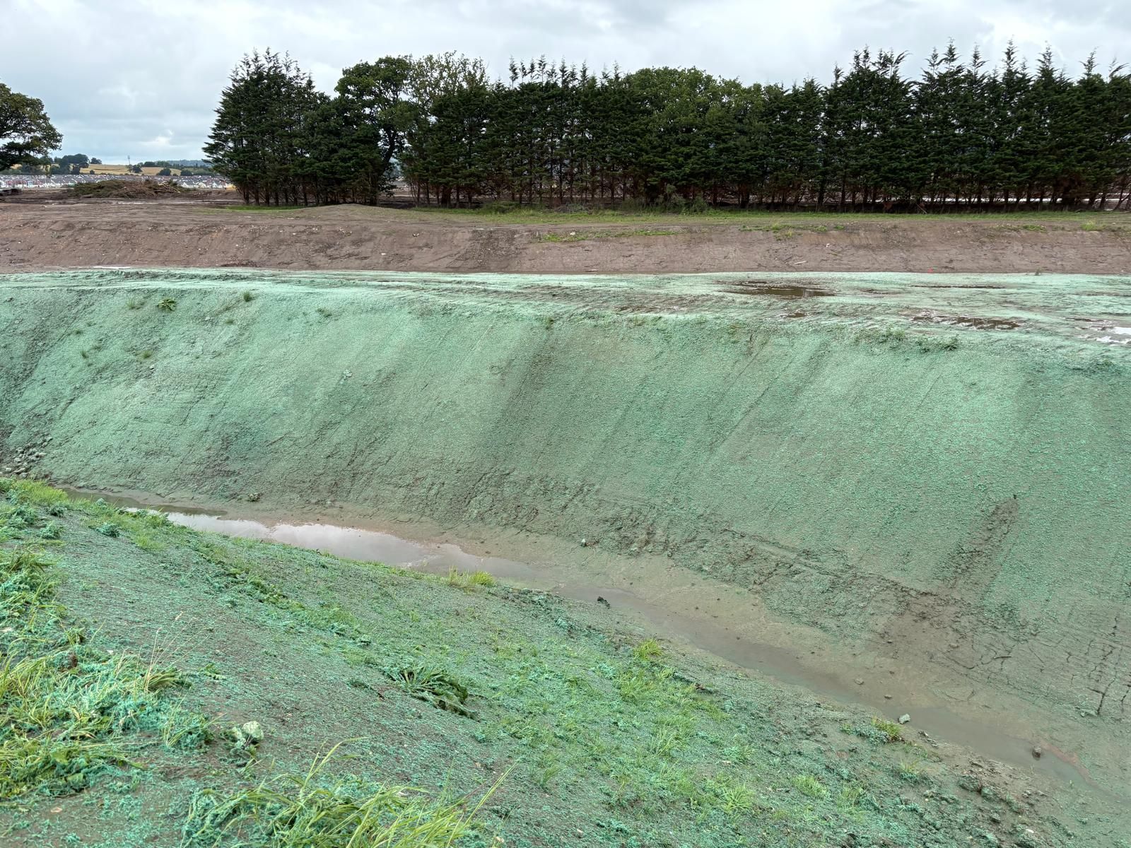 Engineered Fibre Matrix (EFM) erosion control applied to a steep drainage channel