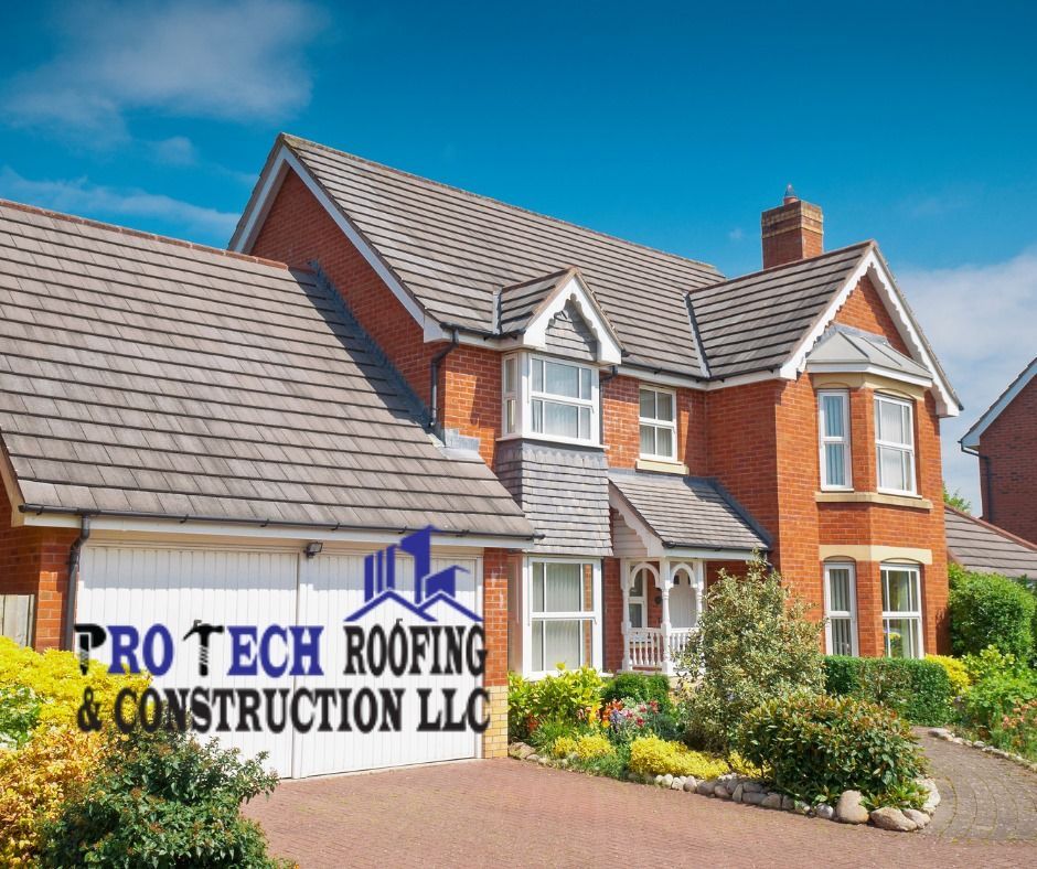 A large brick house with a sign that says pro tech roofing & construction llc