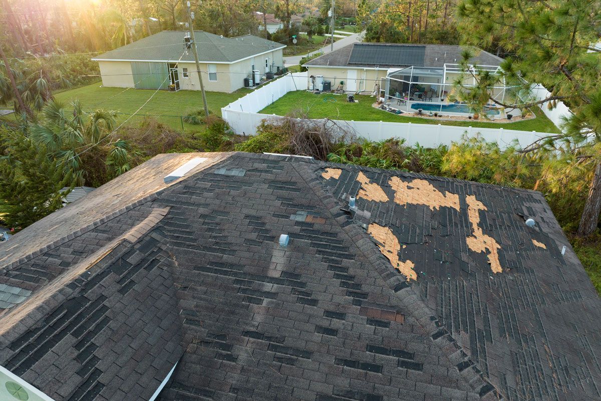 An aerial view of a roof that has been damaged by a hurricane.