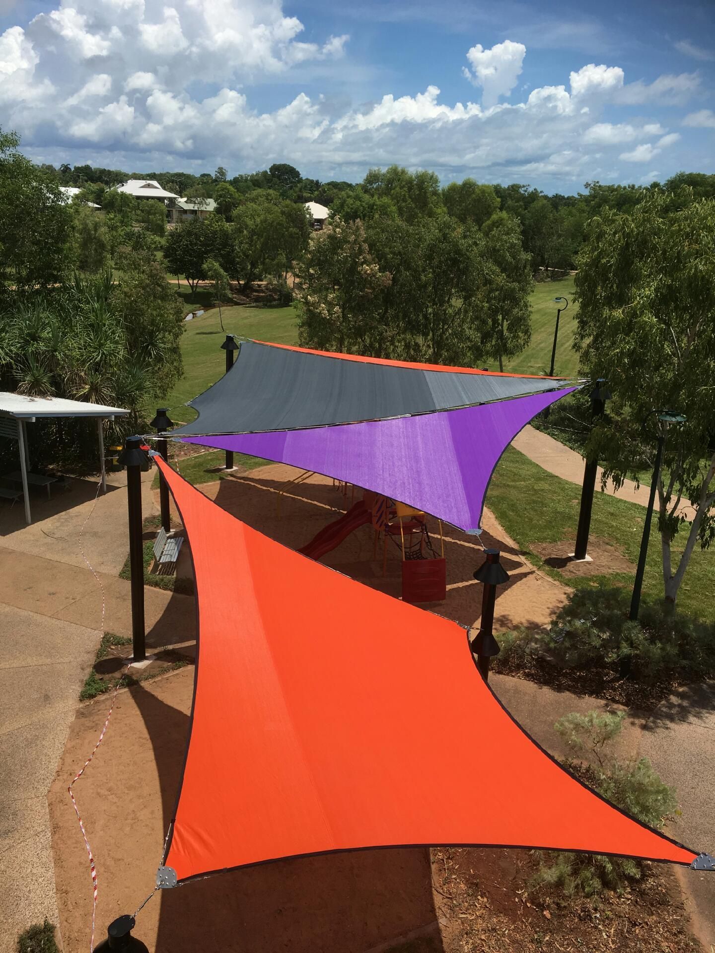 A Row Of Orange And Red Triangle Shades Hanging From A Wire — Aerosail Engineered Fabric Structures In Winnellie, NT