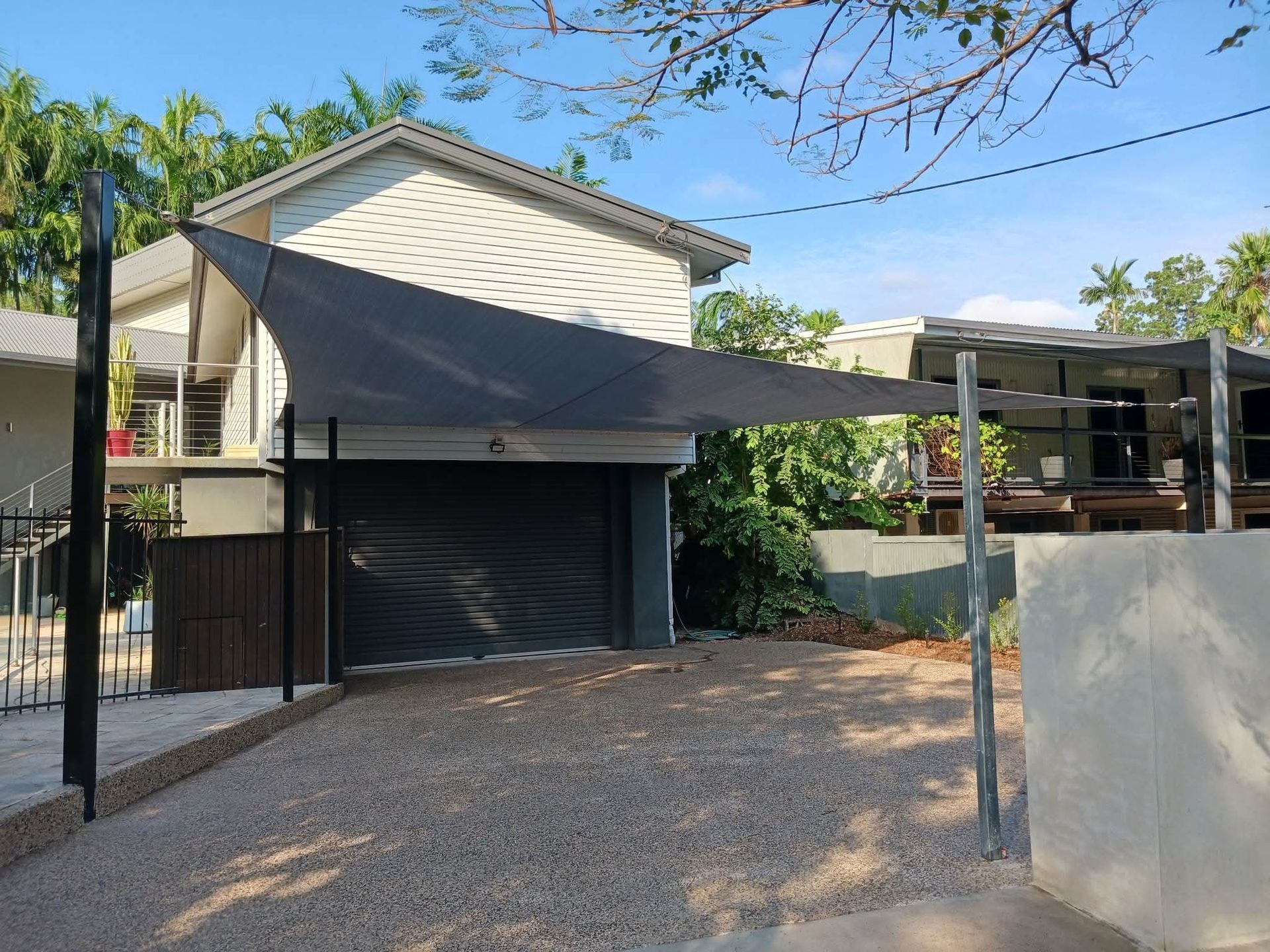 A White House With A Black Awning On The Side Of It — Aerosail Engineered Fabric Structures In Winnellie, NT