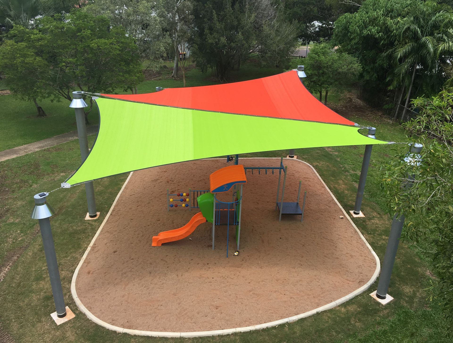 Whittle Park With A Large Orange and Green Shade Over It — Aerosail Engineered Fabric Structures In Winnellie, NT