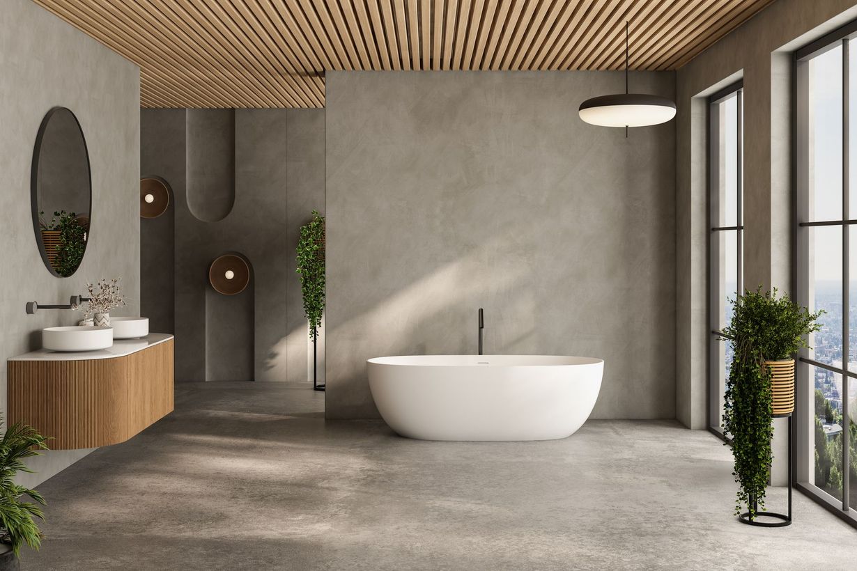 Modern bathroom with a white tub, wooden vanity, and large windows.