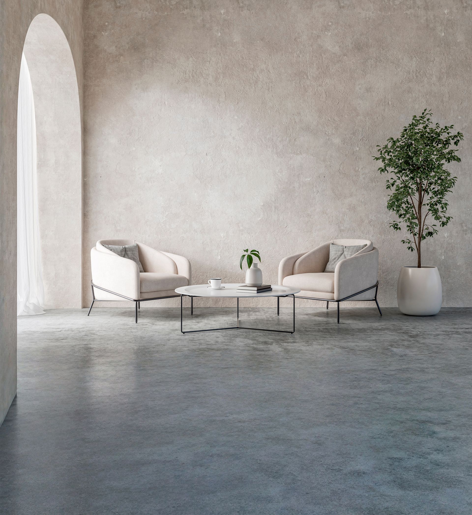 Two beige armchairs facing each other by a marble coffee table in a minimalist, light-filled room with a potted tree.