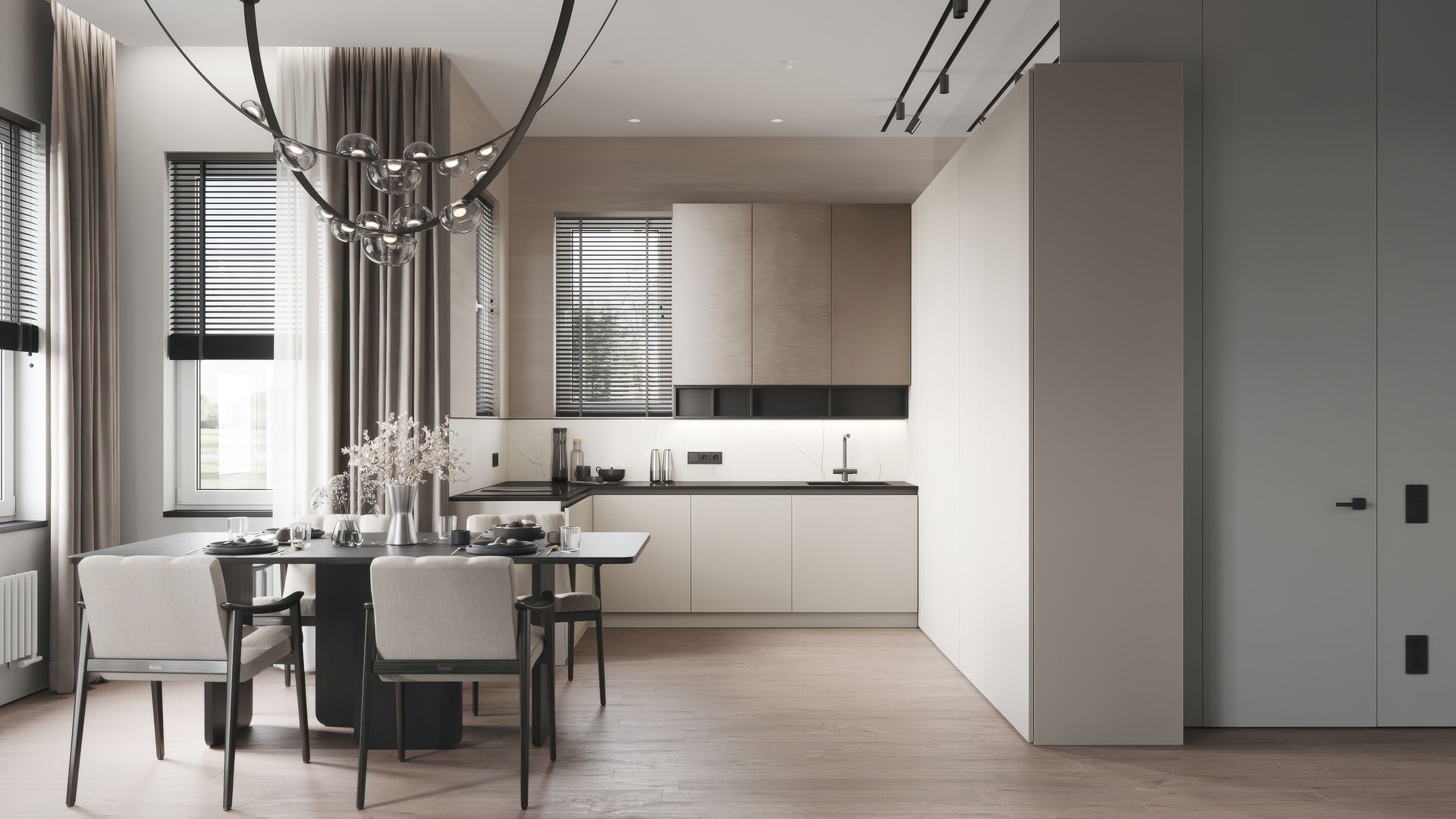 Modern dining room and kitchen with light wood floor, white cabinets, dark countertops, and a large chandelier.