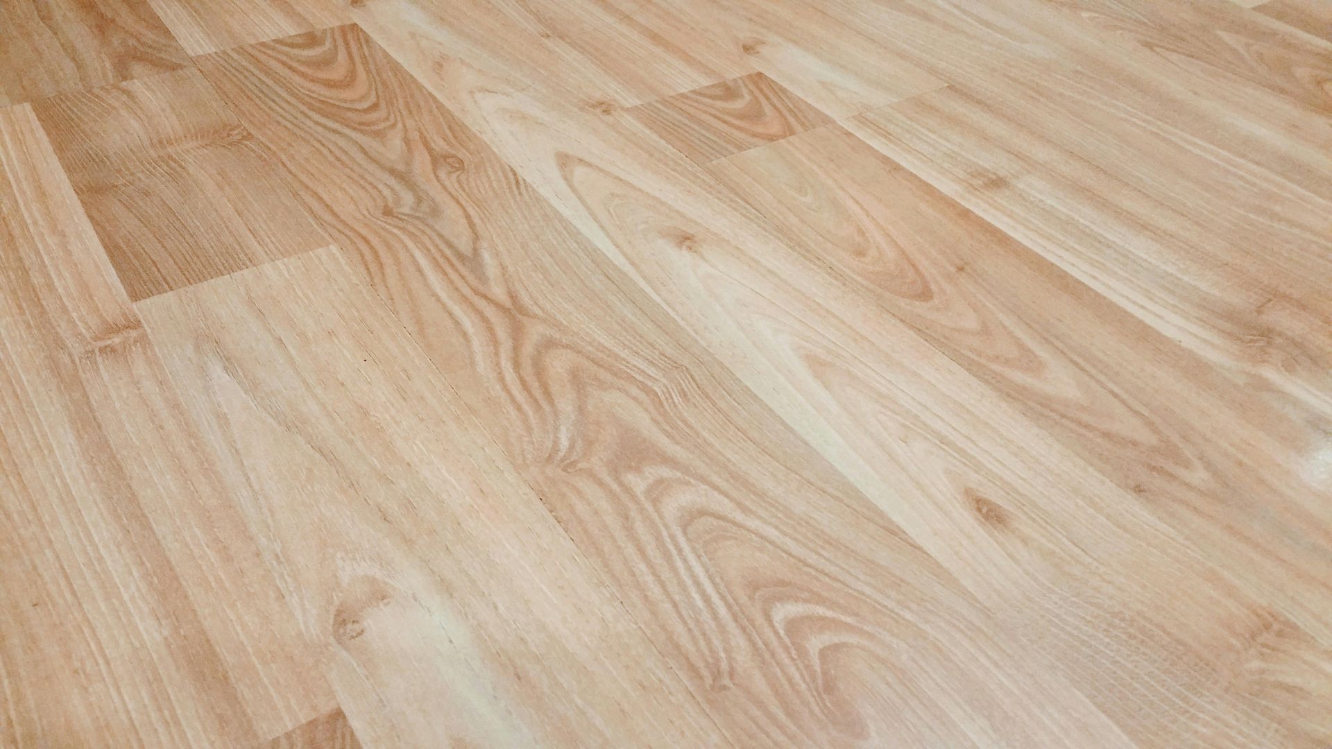 A close up of a wooden floor in a room.