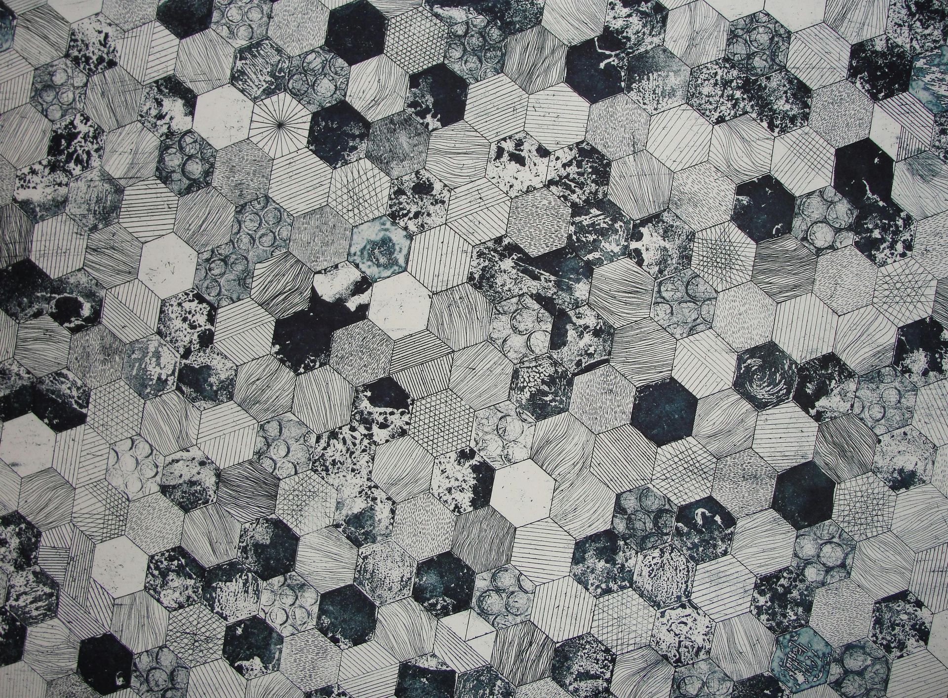 A black and white quilt with a pattern of hexagons