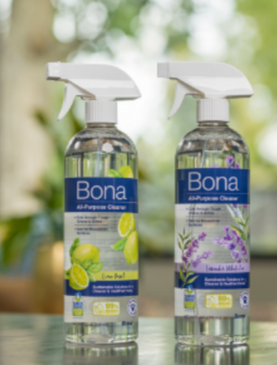 Two spray bottles of Bona All-Purpose Cleaner, one Lime Basil and one Lavender White Tea, stand side by side on a surface.