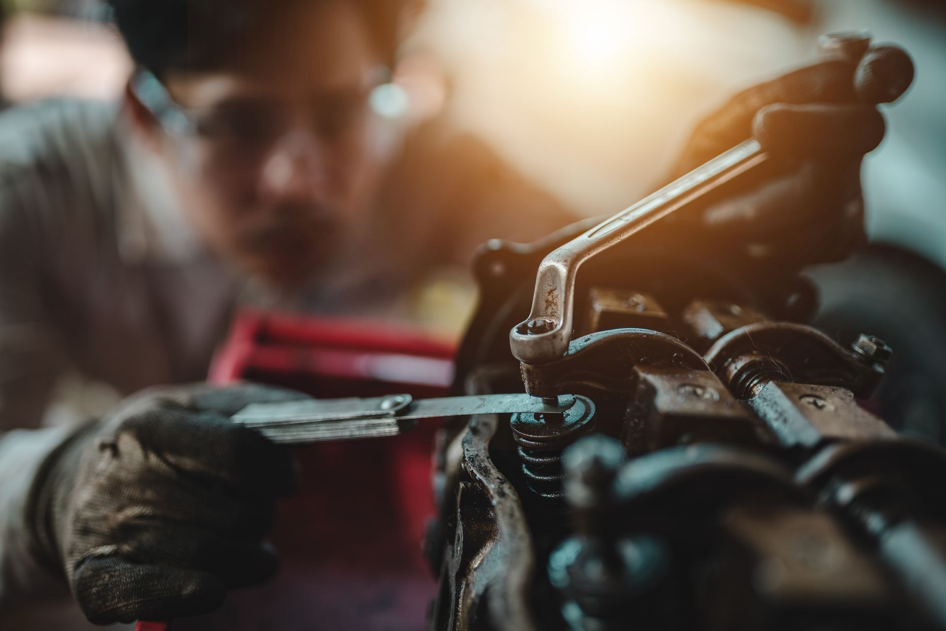 A man is working on a machine with a wrench.