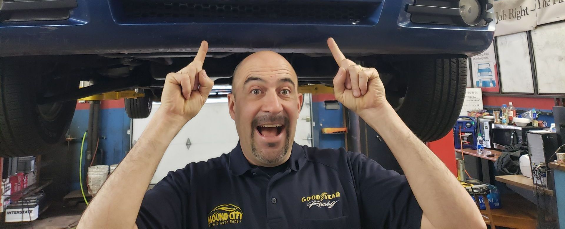 A man is working on a machine with a wrench.