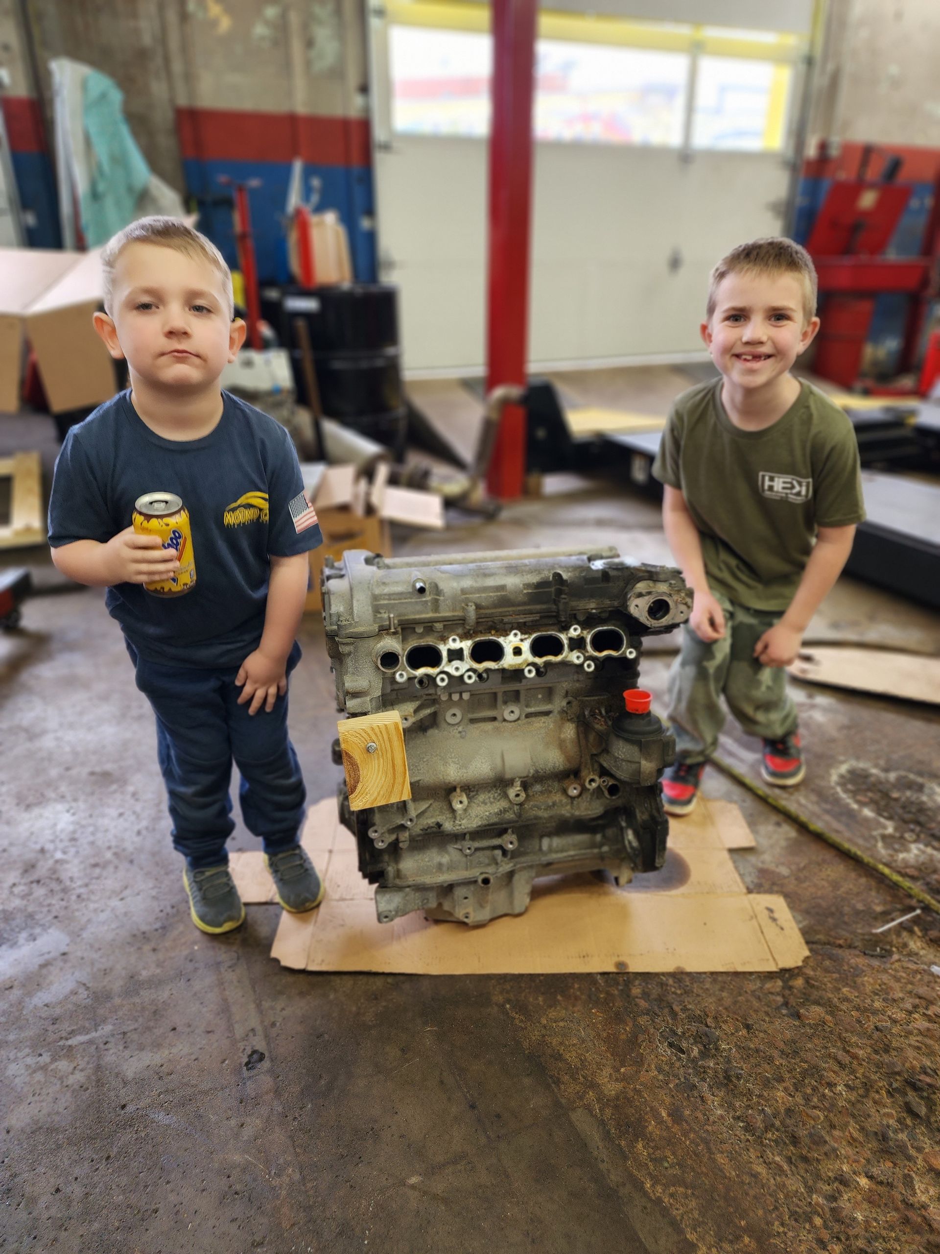 A close up of a car engine with belts and pulleys.