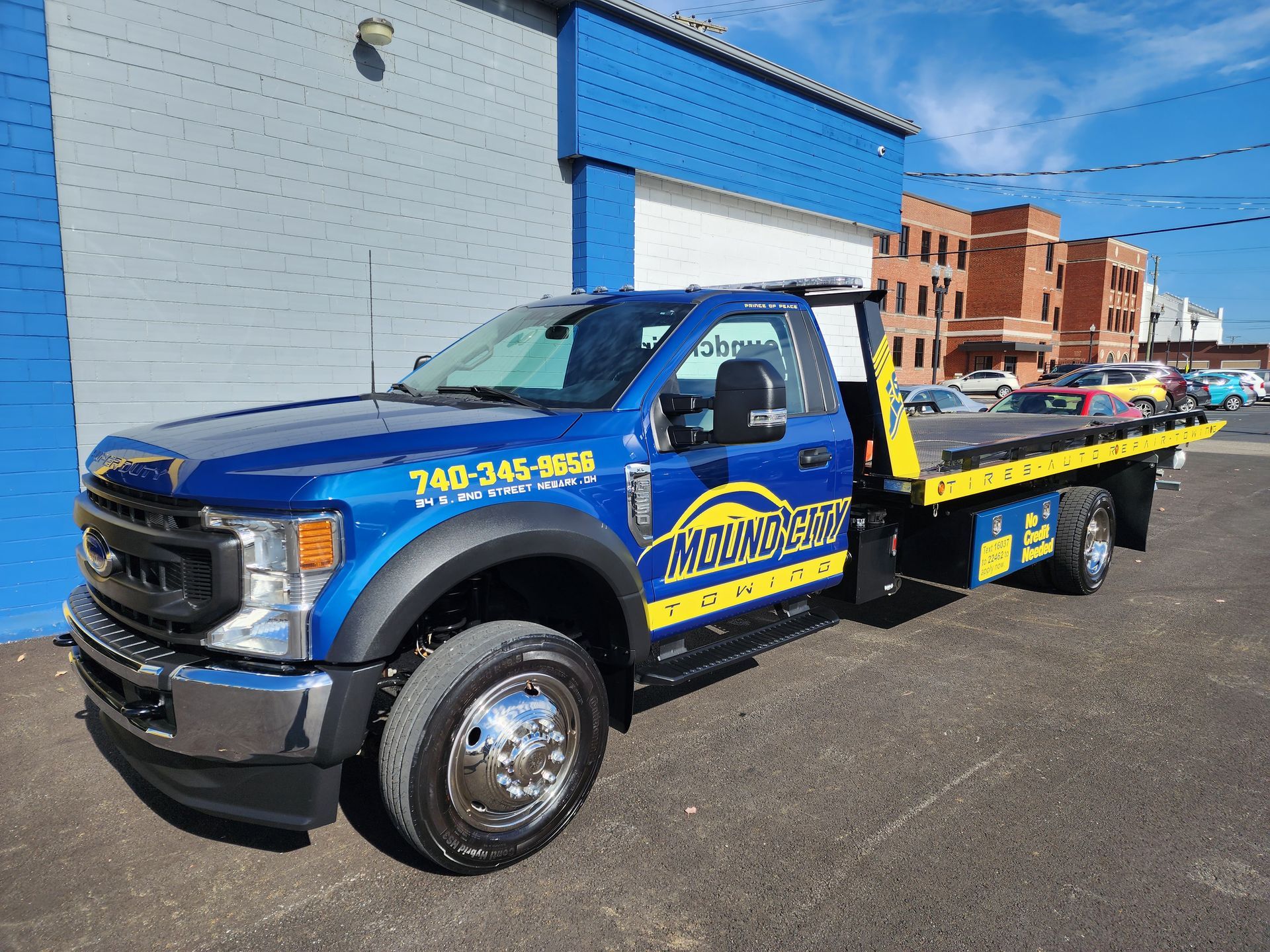 A car is being towed by a tow truck.