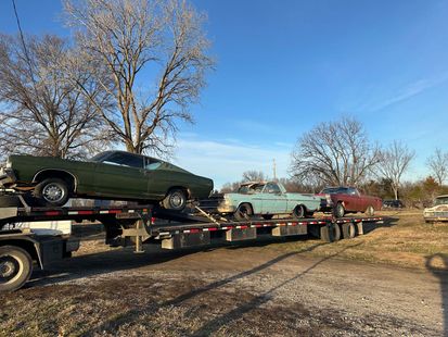 Gooseneck trailer hauling classic cars 