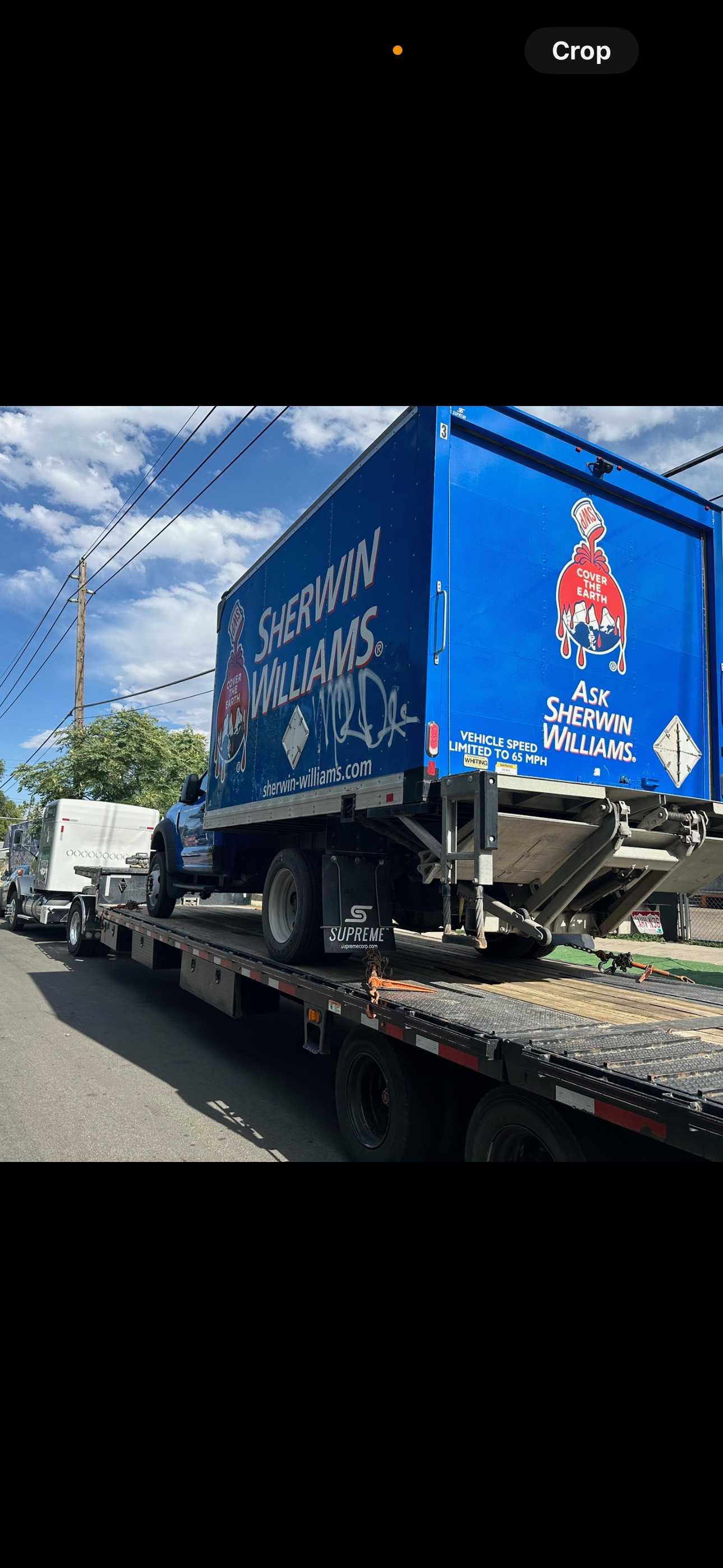water tanks and other construction equipment safely strapped on to flatbed gooseneck trailer ready to be transported with speed and safety