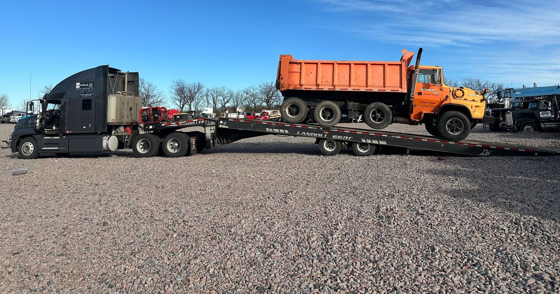 construction equipment on trailer in the snowy mountains