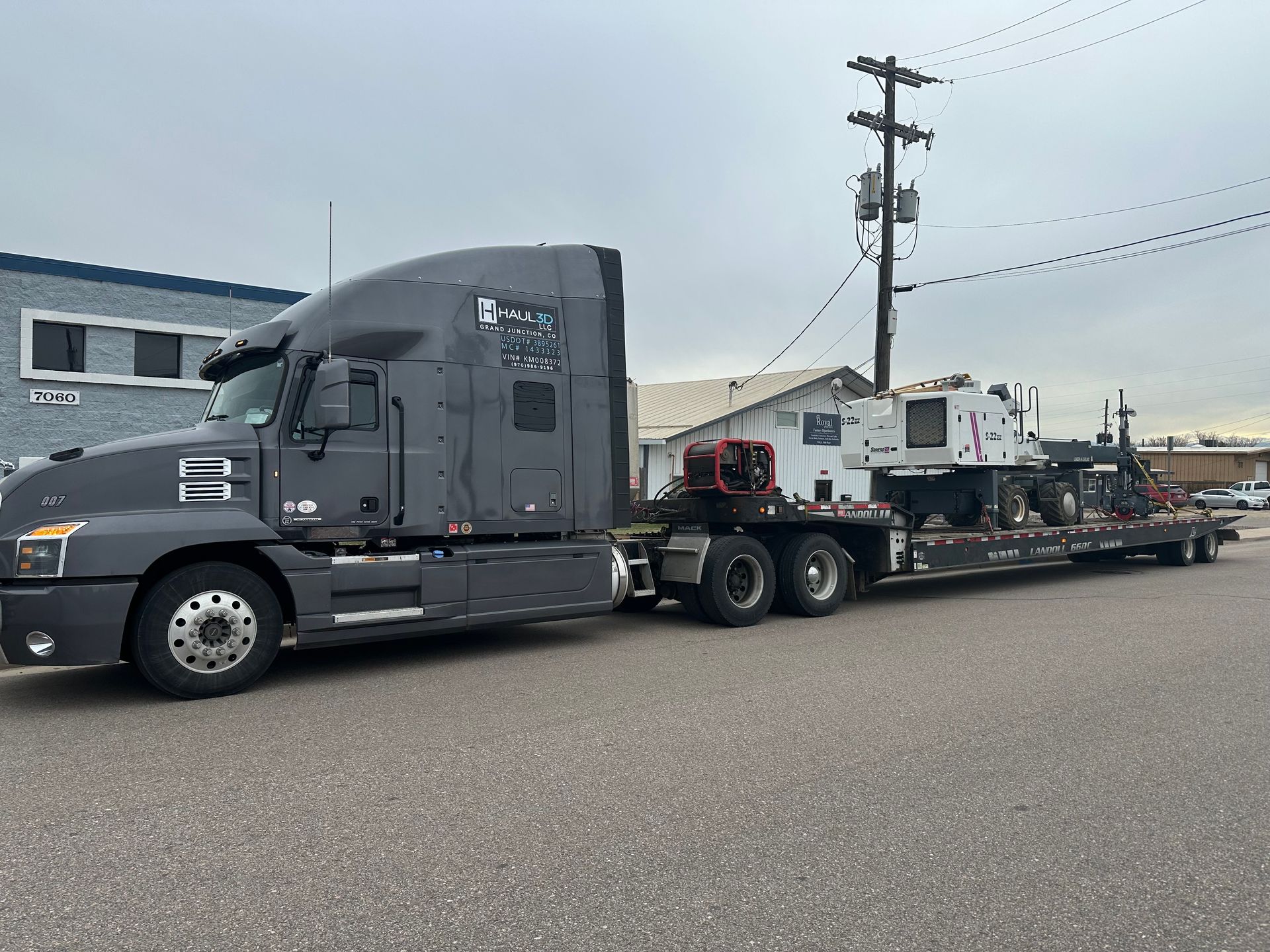 storage container strapped on flatbed trailer to be transported