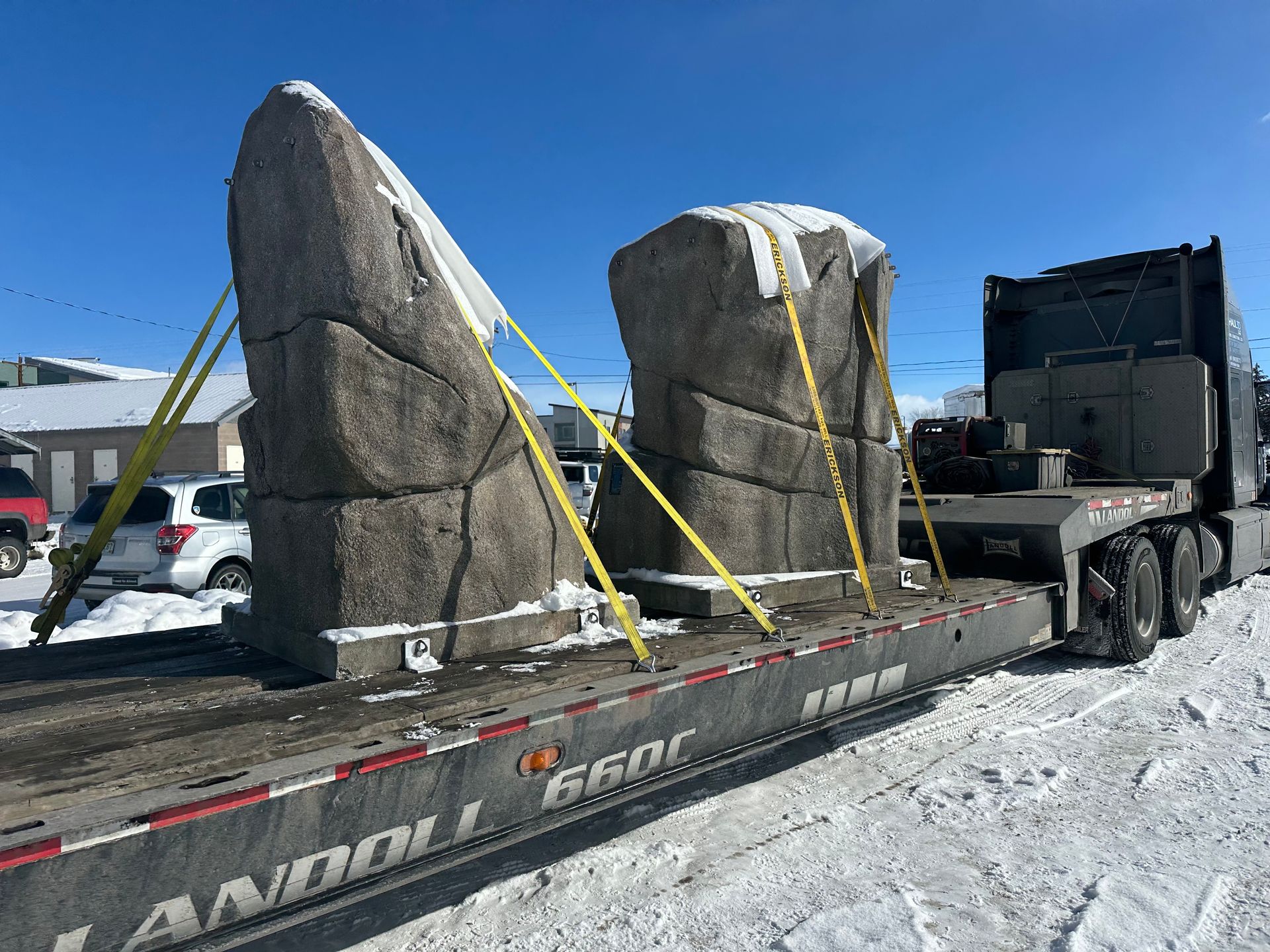 construction track equipment on trailer haul3d at gas station