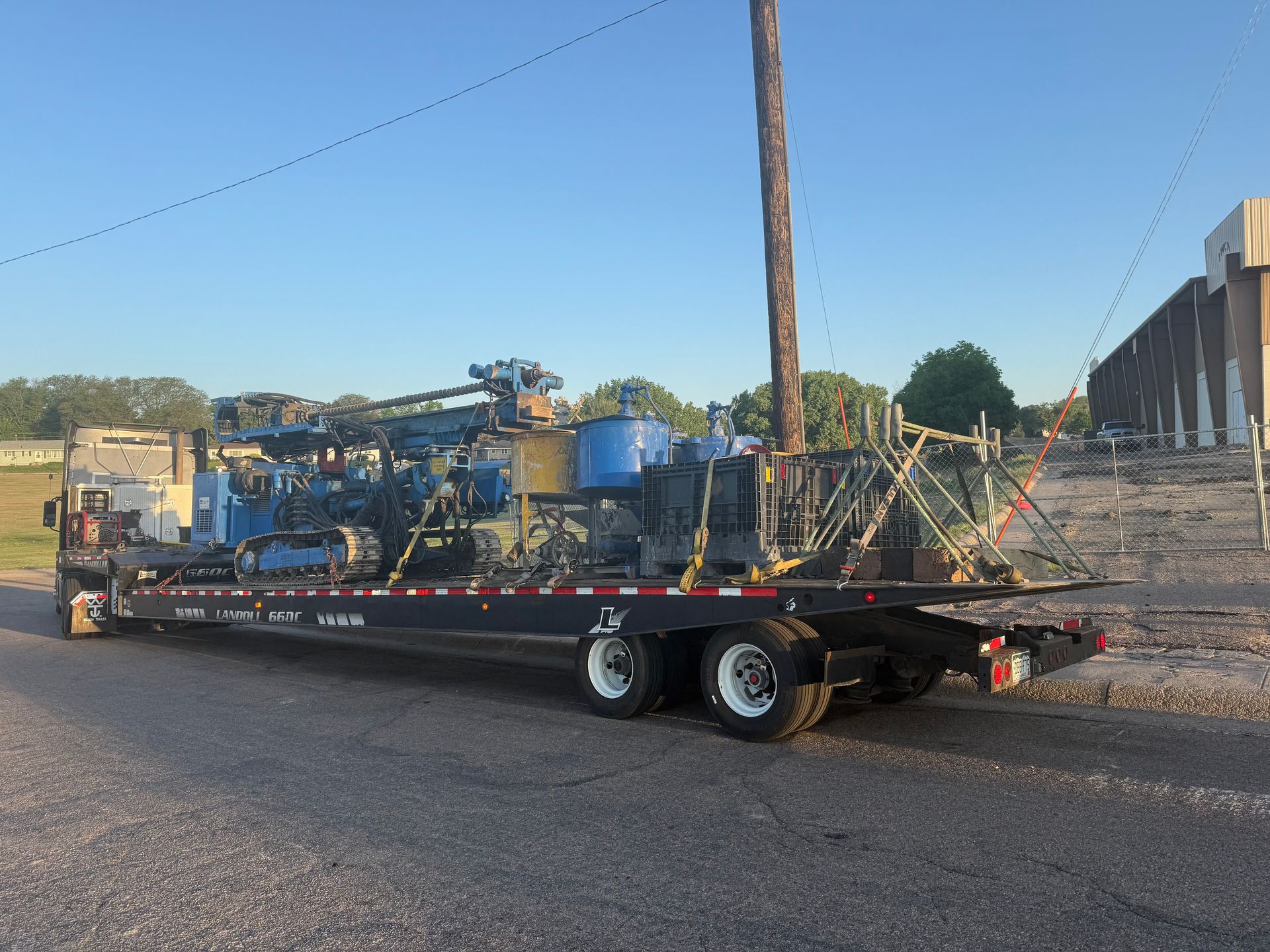 tarped equipment transported on flatbed trailer