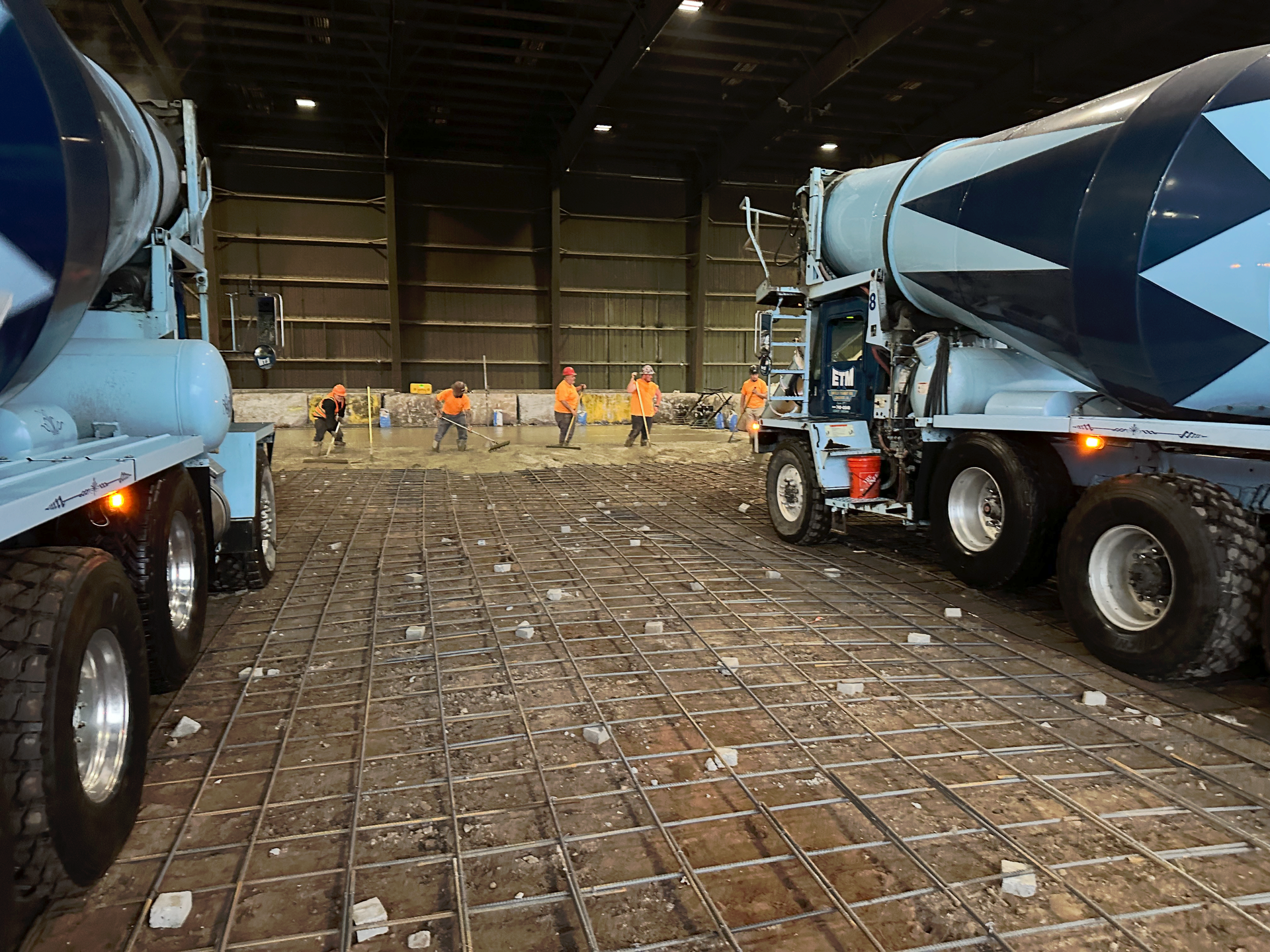 A concrete mixer truck is parked in a warehouse.