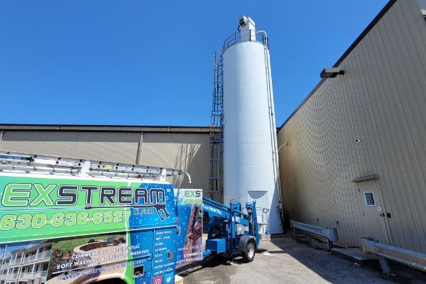 An exstream truck is parked in front of a building