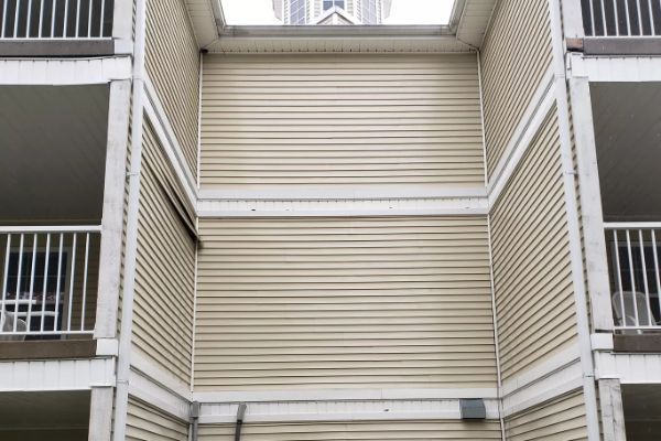 A building with a lot of balconies and siding on it.