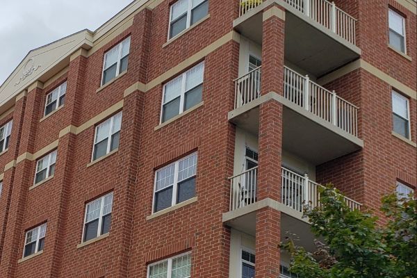 A large brick building with many windows and balconies
