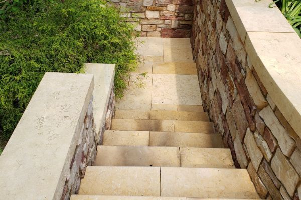 A set of stairs leading up to a stone wall
