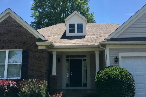 A house with a roof that has a window on it