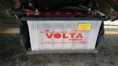 Volta Power R155 battery mounted in a vehicle. It is white with red and black accents.