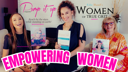 Three women are holding books in front of a sign that says empowering women.