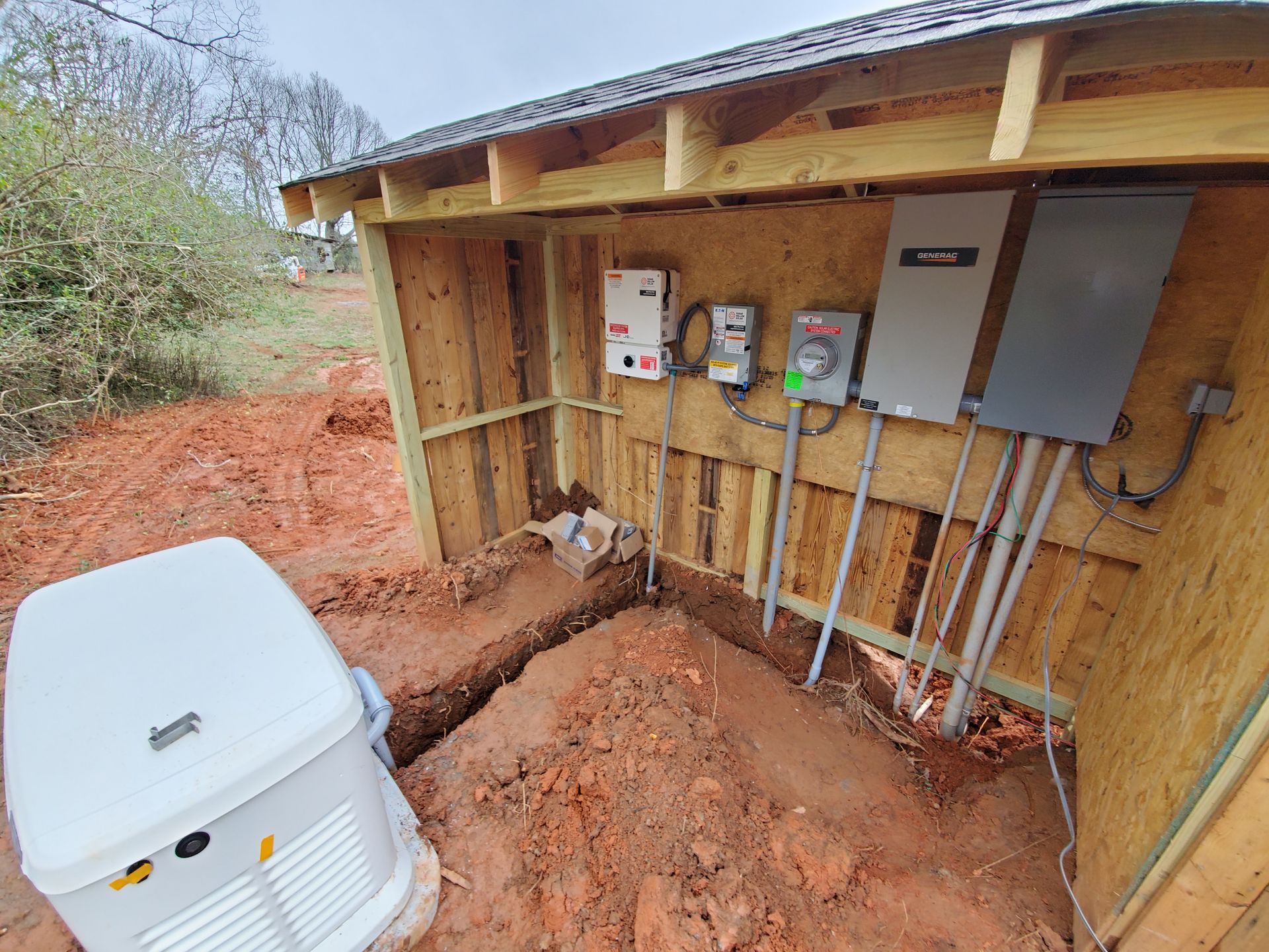 A wooden shed with a generator inside of it.