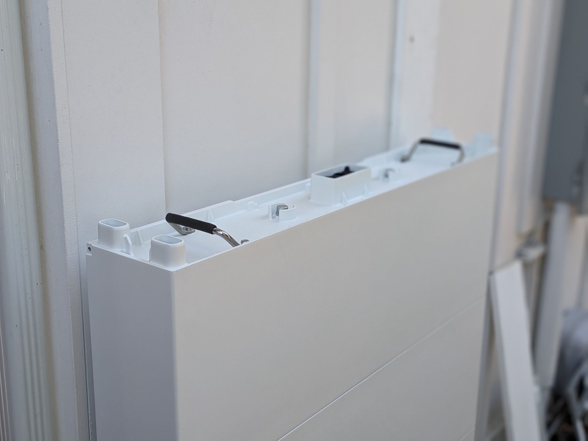 A white box is sitting on a white wall.